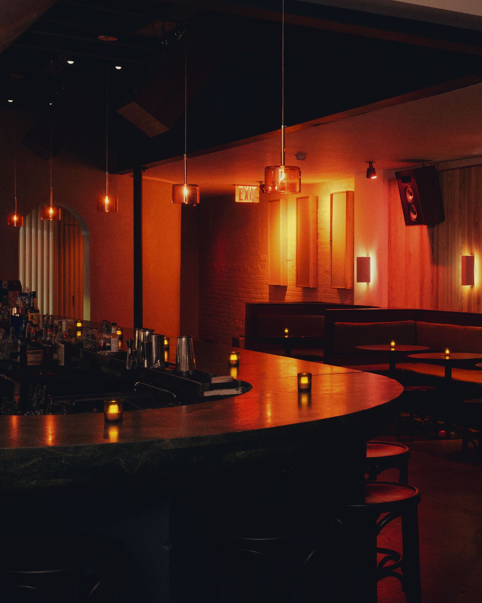 Image may contain Lamp Electronics Speaker Urban Desk Furniture Table Bar Candle and Cup